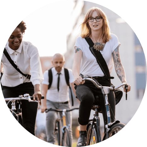 Three people dressed in work clothes riding on a bike